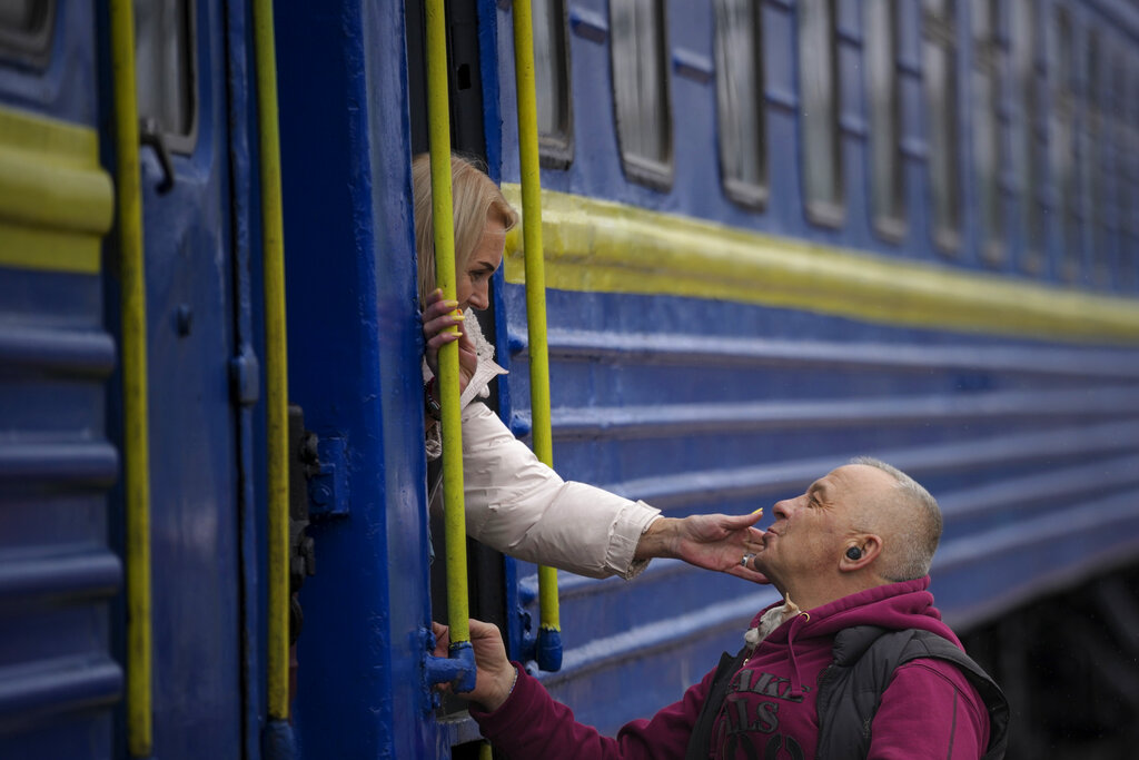 Woman saying goodbye after boarding train in Kyiv 