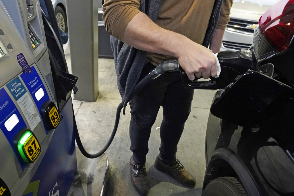 A customer pumps gasoline into his car at a Sam