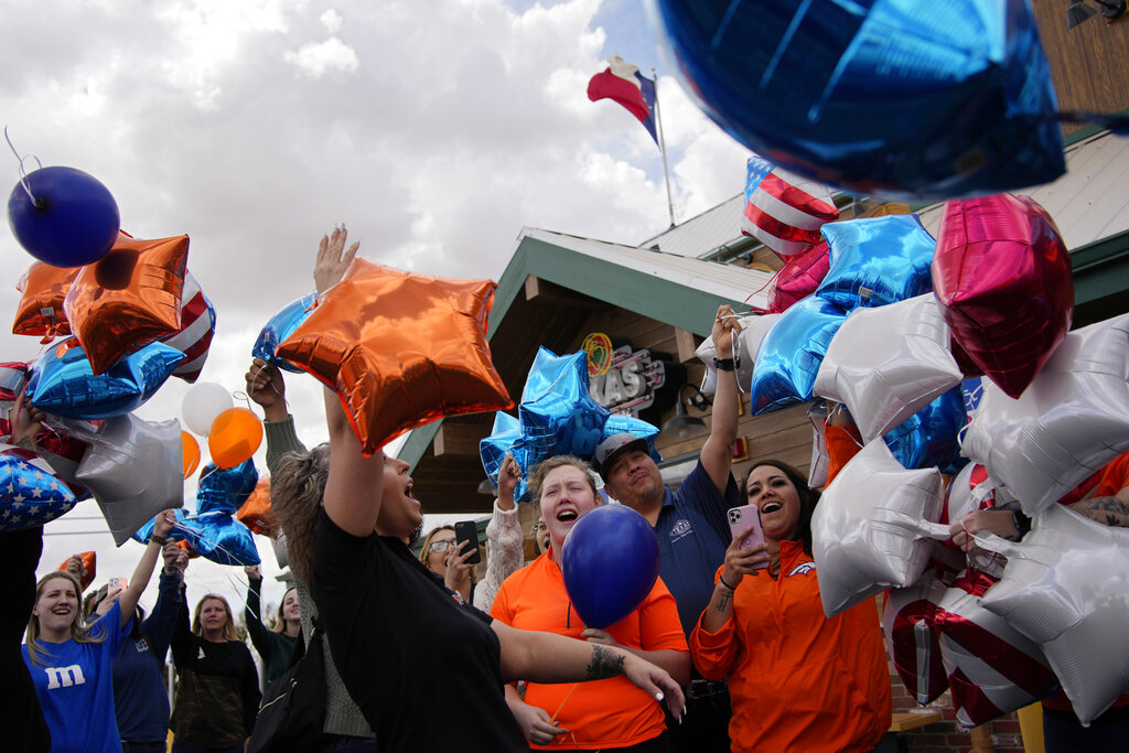 People release balloons during a memorial for Jackson Zinn at a Texas Roadhouse restaurant
