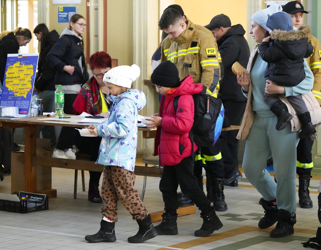 Children from Ukraine receive soup at a railway station in Poland