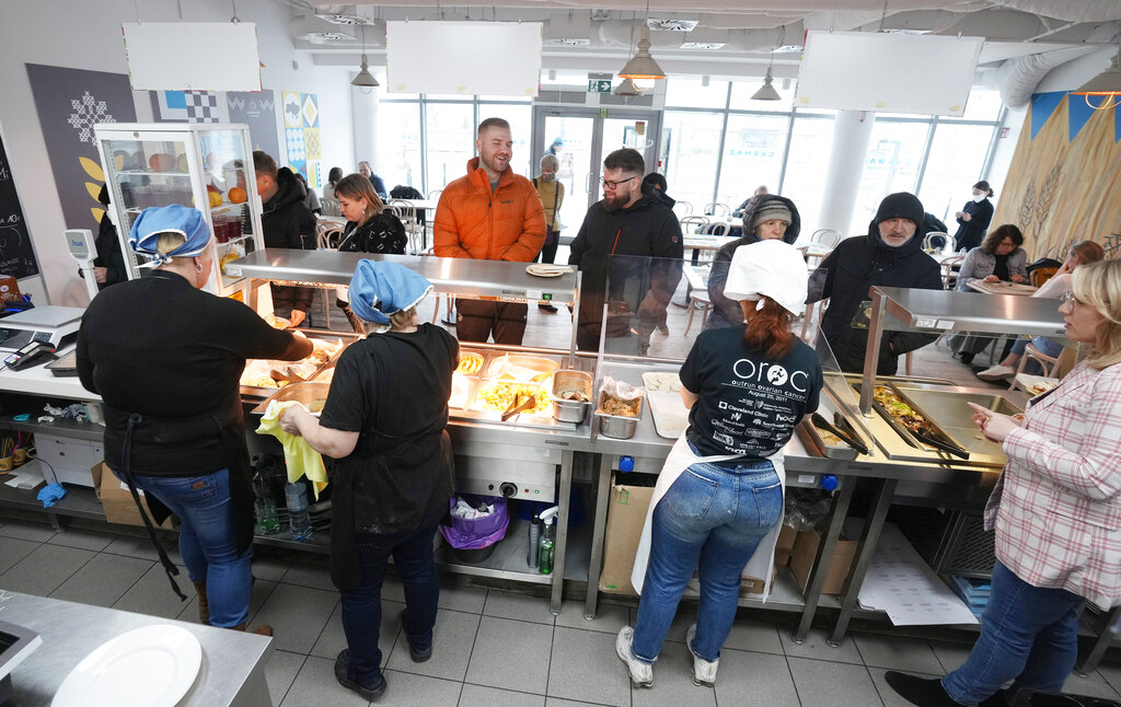 Ukrainian refugee women working at a Ukrainian food bar that a private foundation has opened to offer jobs to the refugees