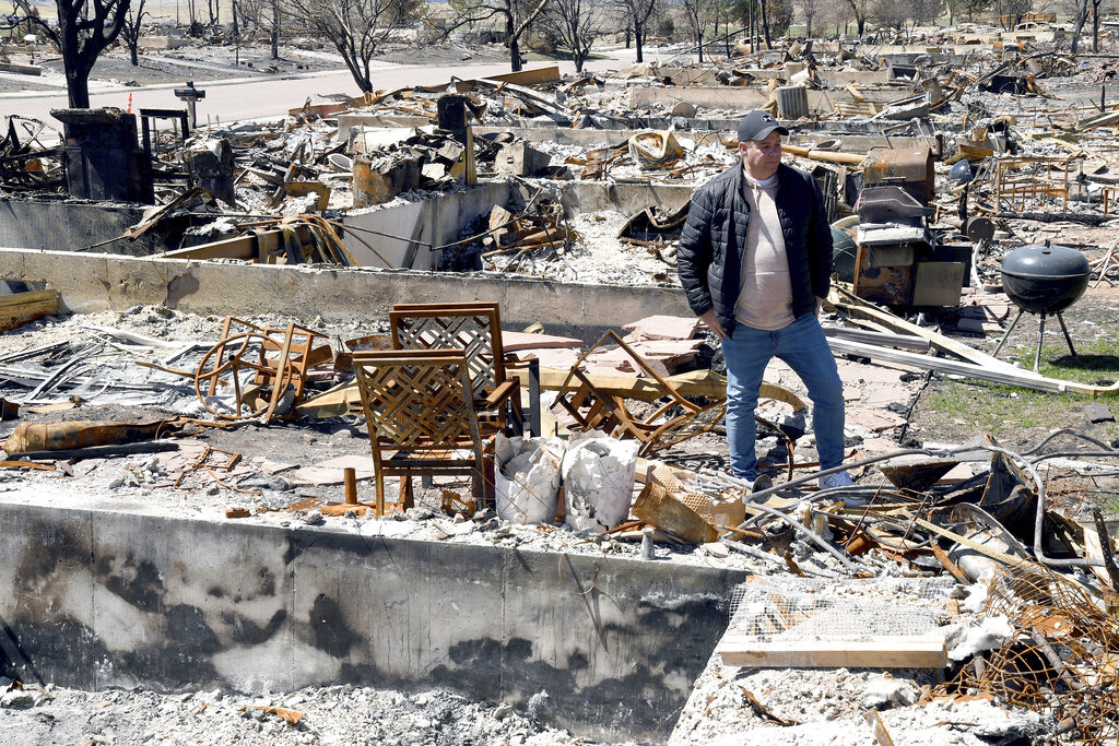 Pastor Bill Stephens surveys the charred remains of his home in Superior, Colo.