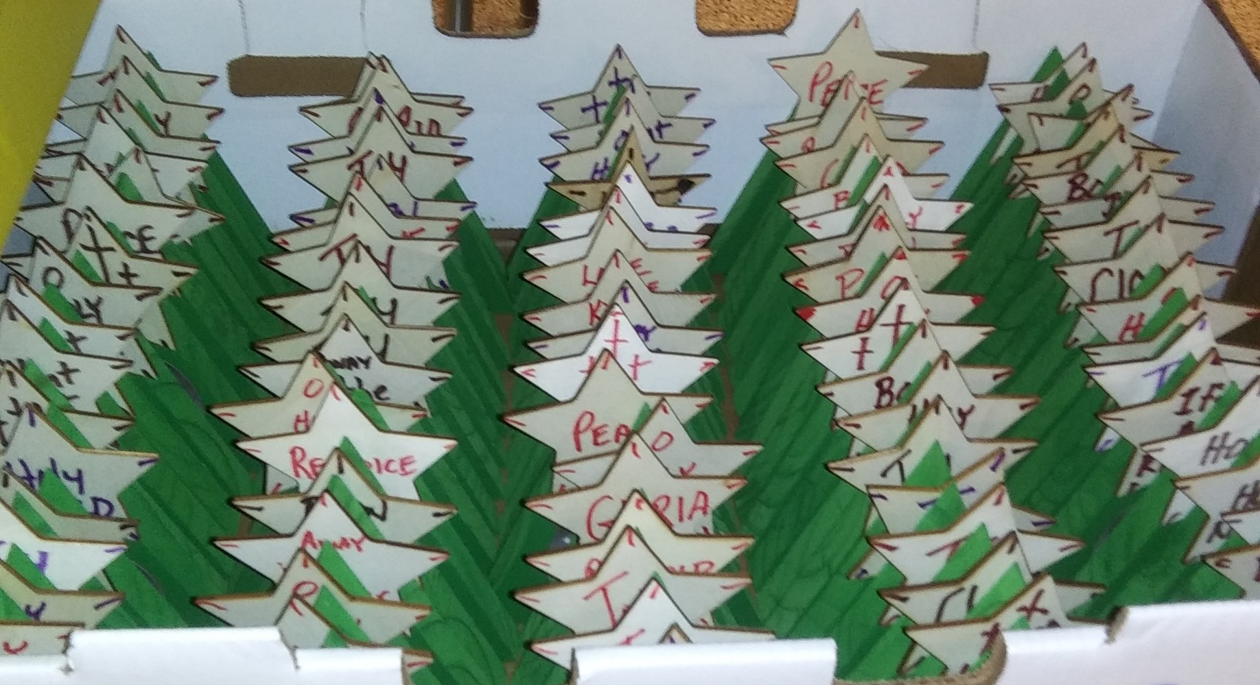 Wooden Christmas trees and stars with names on them