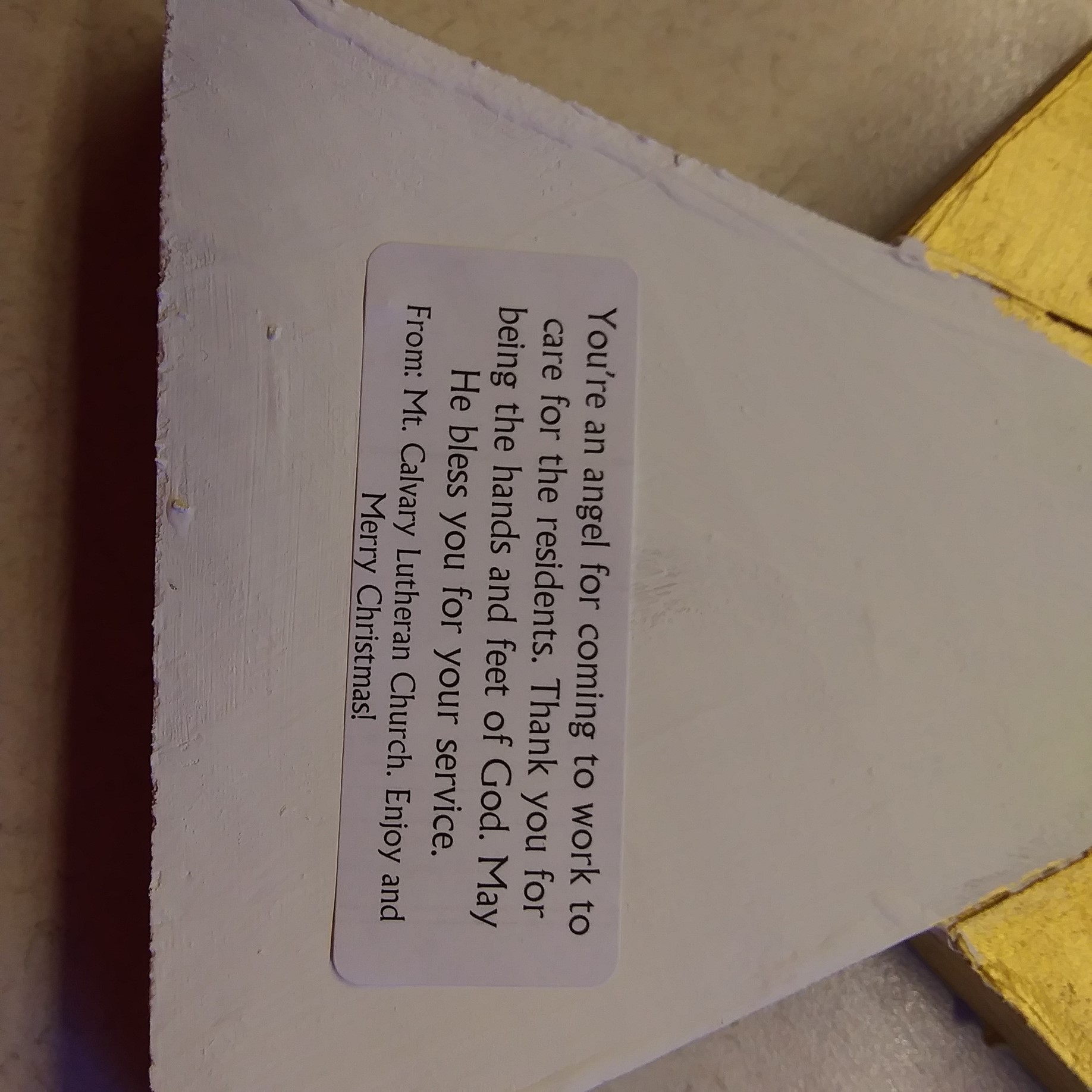Note attached to wooden angel