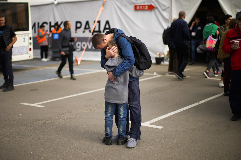 Andrii Fedorov hugs his son Makar as they reunited at a reception center for displaced people in Zaporizhzhia, Ukraine