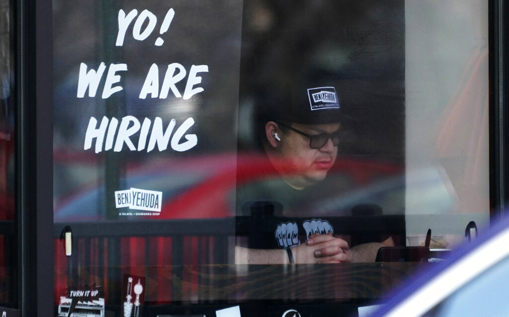 A hiring sign is displayed at a restaurant in Schaumburg, Ill.