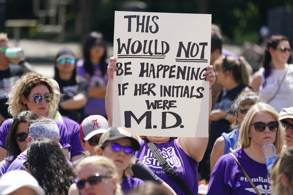 People demonstrate outside the courthouse where the sentencing hearing for former nurse RaDonda Vaught