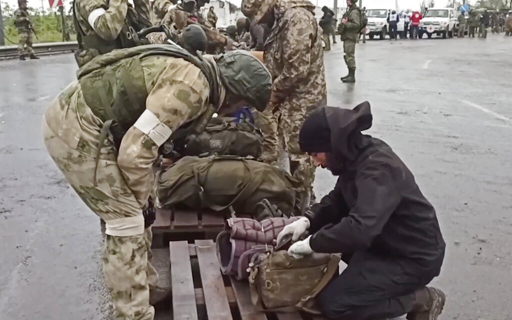 Russian servicemen frisking Ukrainian servicemen after they leaved the besieged Azovstal steel plant in Mariupol