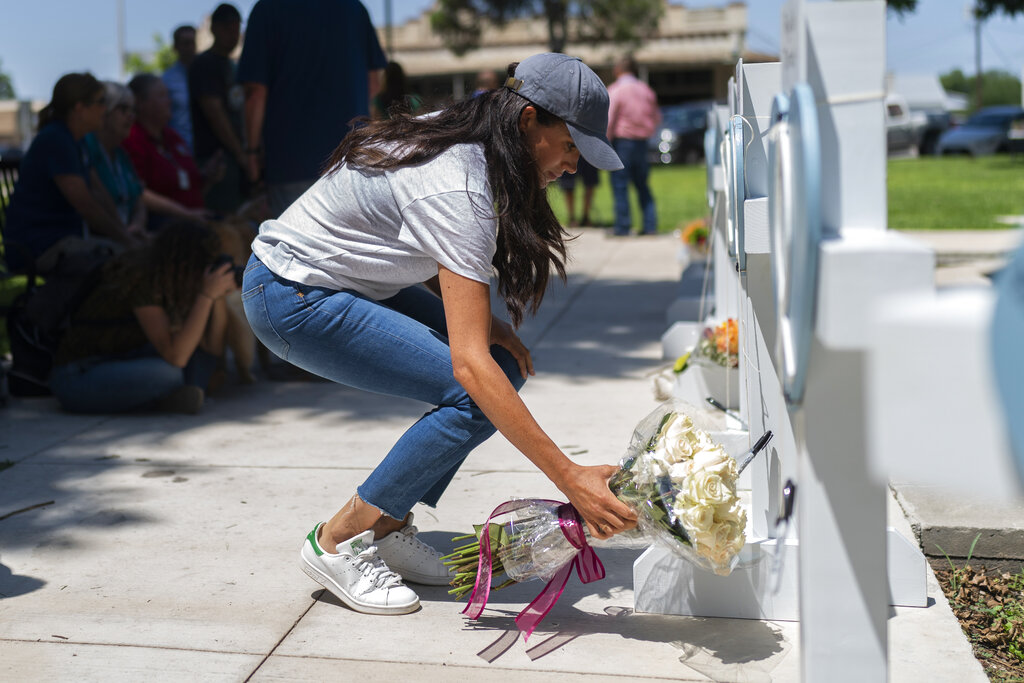 Meghan Markle, Duchess of Sussex, leaves flowers at a memorial site for the victims who died at the elementary school shooting in Uvalde, Texas