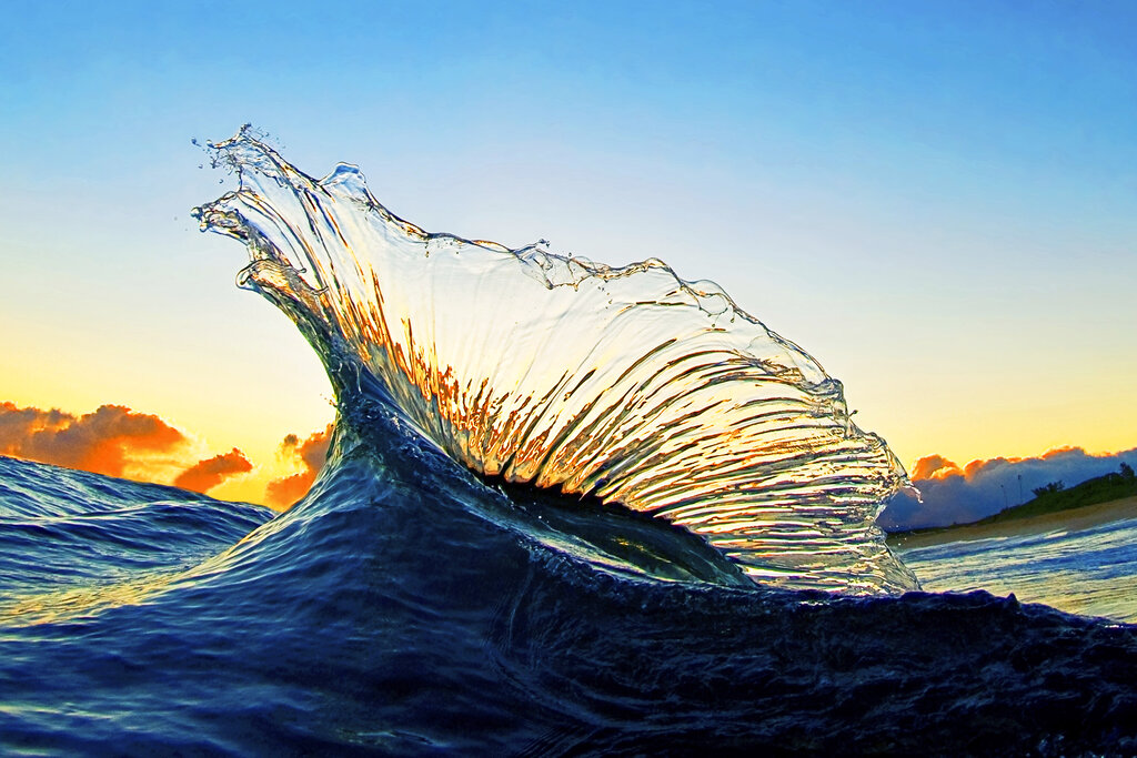 In this undated photo entitled "Marlin," two waves collide at sunrise creating a splash of water that looks like the fin of a marlin on the North Shore of Oahu near Haleiwa, Hawaii.