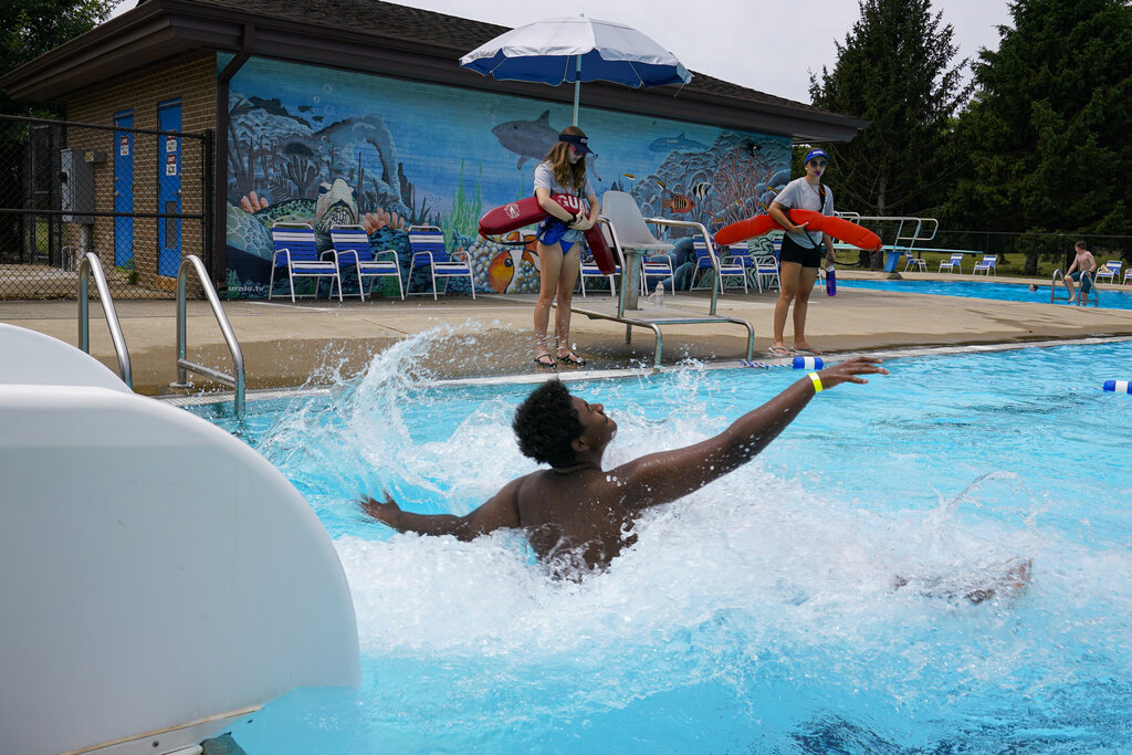 Lifeguards Hailey Landrun, 17, and Rachel Mees, 21, watch over swimmers at the Douglass Park pool in Indianapolis