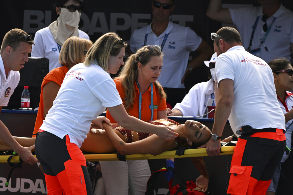 Anita Alvarez of United States is taken on a stretcher from the pool 