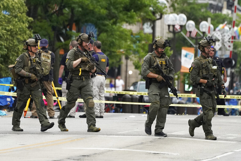 Law enforcement search after a mass shooting at the Highland Park Fourth of July parade in downtown Highland Park, Ill.