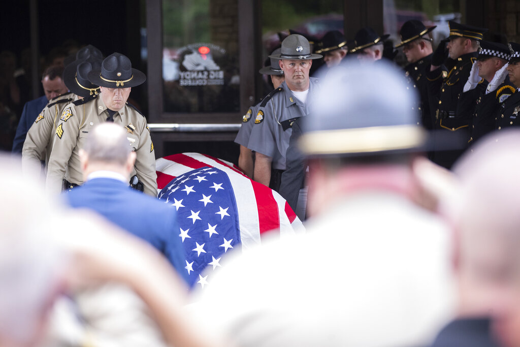 Law enforcement officers carry the casket of Floyd County Deputy William Petry to the hearse 