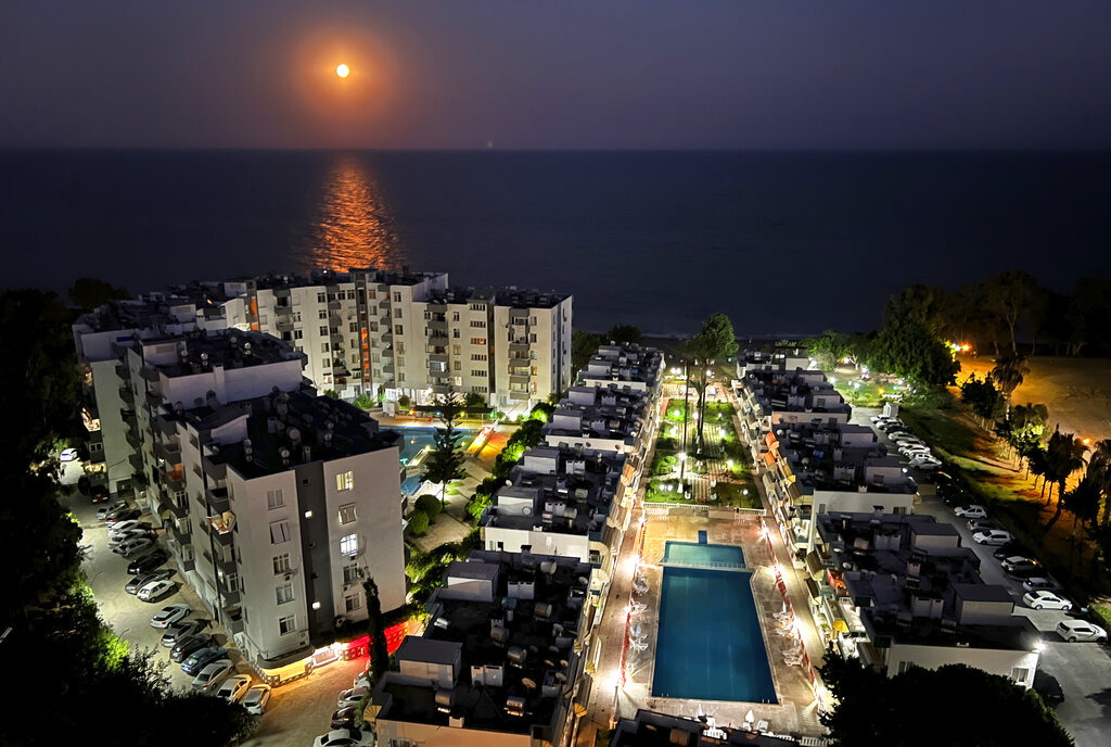 A supermoon rises over the Mediterranean Sea