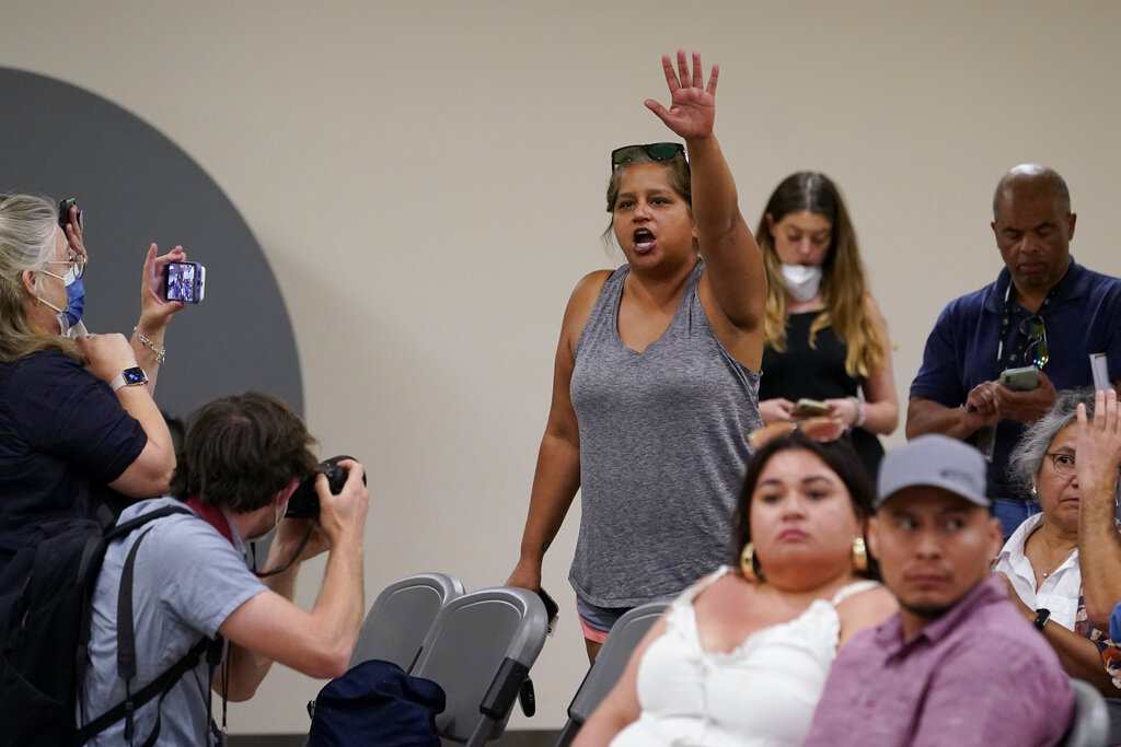 Tina Quintanilla-Taylor raises her and and voice as she tries to ask a question of the Texas House investigative committee at a news conference after they released its full report on the shootings at Robb Elementary School