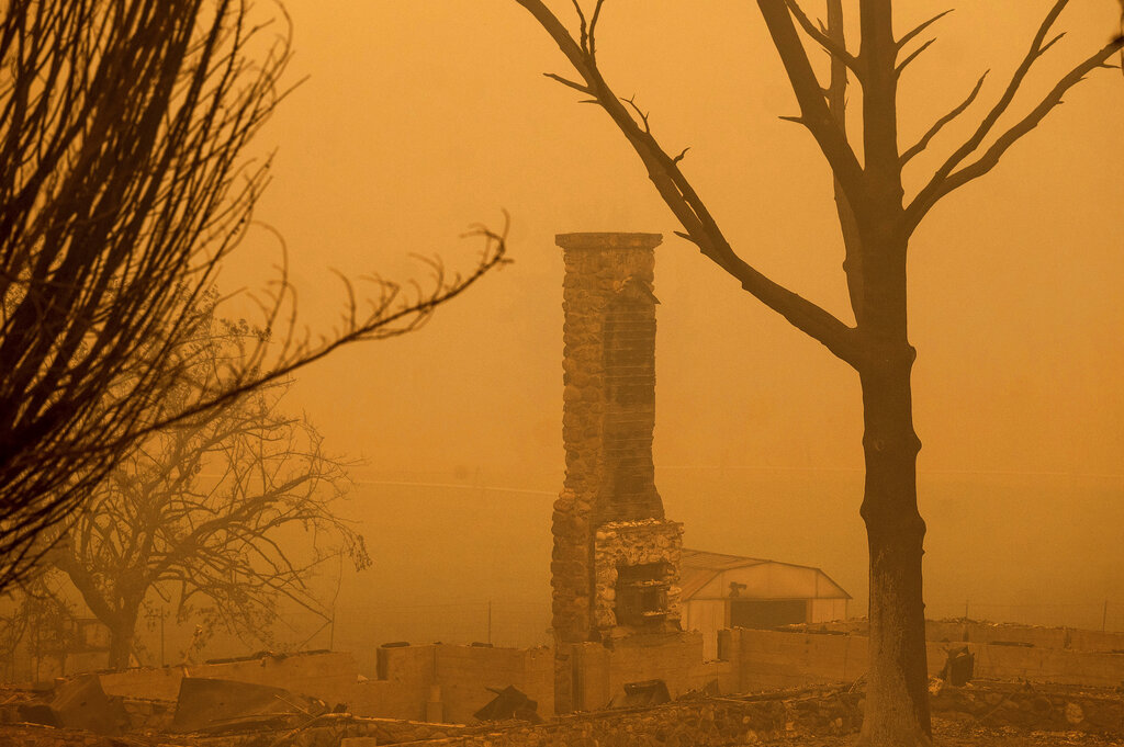 A chimney stands at a destroyed building as the McKinney Fire burns in Klamath National Forest, Calif.