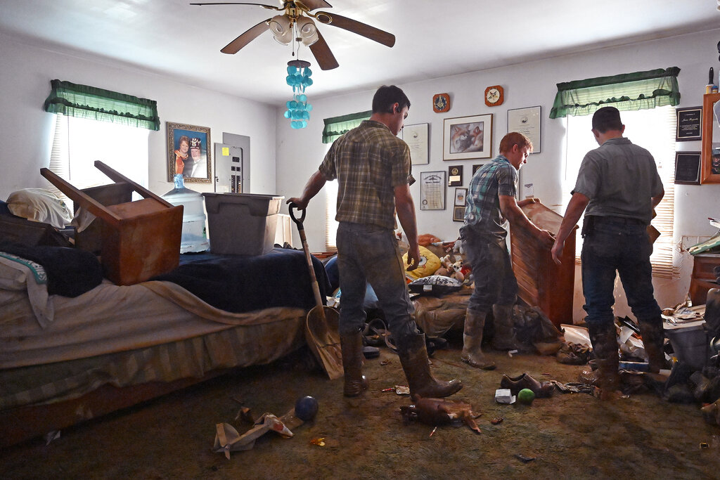 Volunteers from the local mennonite community clean flood damaged property from a house at Ogden Hollar in Hindman, Ky.