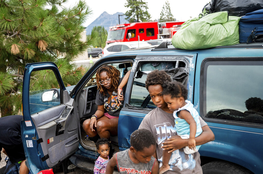Paisley Bamberg and her family spend time outside a shelter for McKinney Fire evacuees in Weed, Calif.