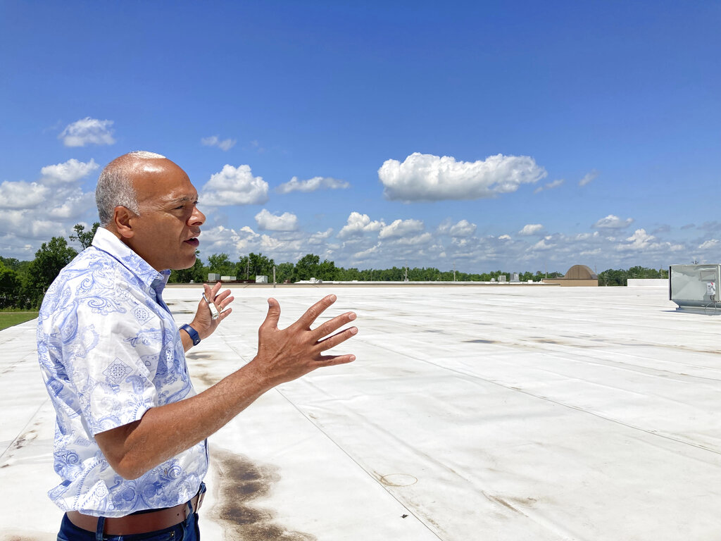  Neil Bernard, pastor of New Wine Christian Fellowship in LaPlace, La., gestures to where solar panels will be installed on the roof of part of his church. 