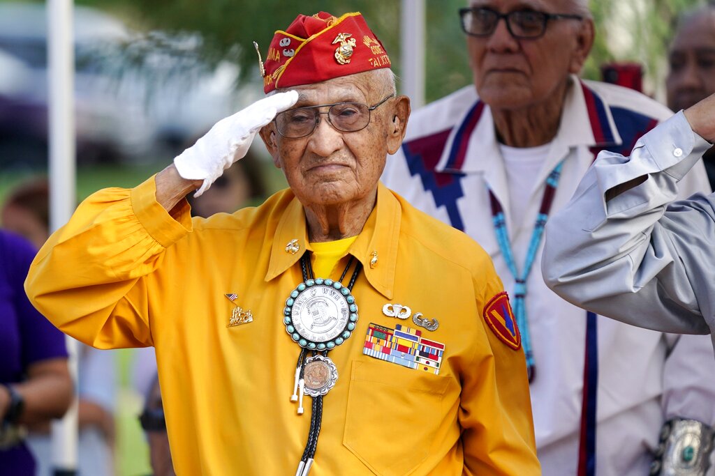 Navajo Code Talker Thomas Begay salutes during the national anthem at the Arizona State Navajo Code Talkers Day celebration