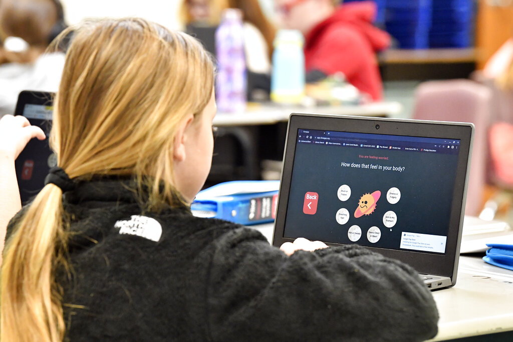 Student at Lakewood Elementary School in Cecilia, Ky., uses her laptop to participate in an emotional check-in at the start of the school day