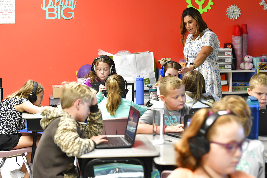 Angela Pike watches her fourth grade students at Lakewood Elementary School in Cecilia, Ky., as they use their laptops to participate in an emotional check-in at the start of the school day