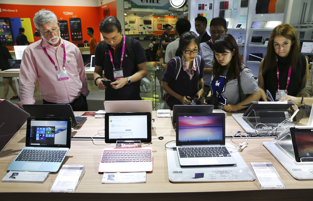 Visitors review new Asus computer products at the Computex trade show in Taipei, Taiwan