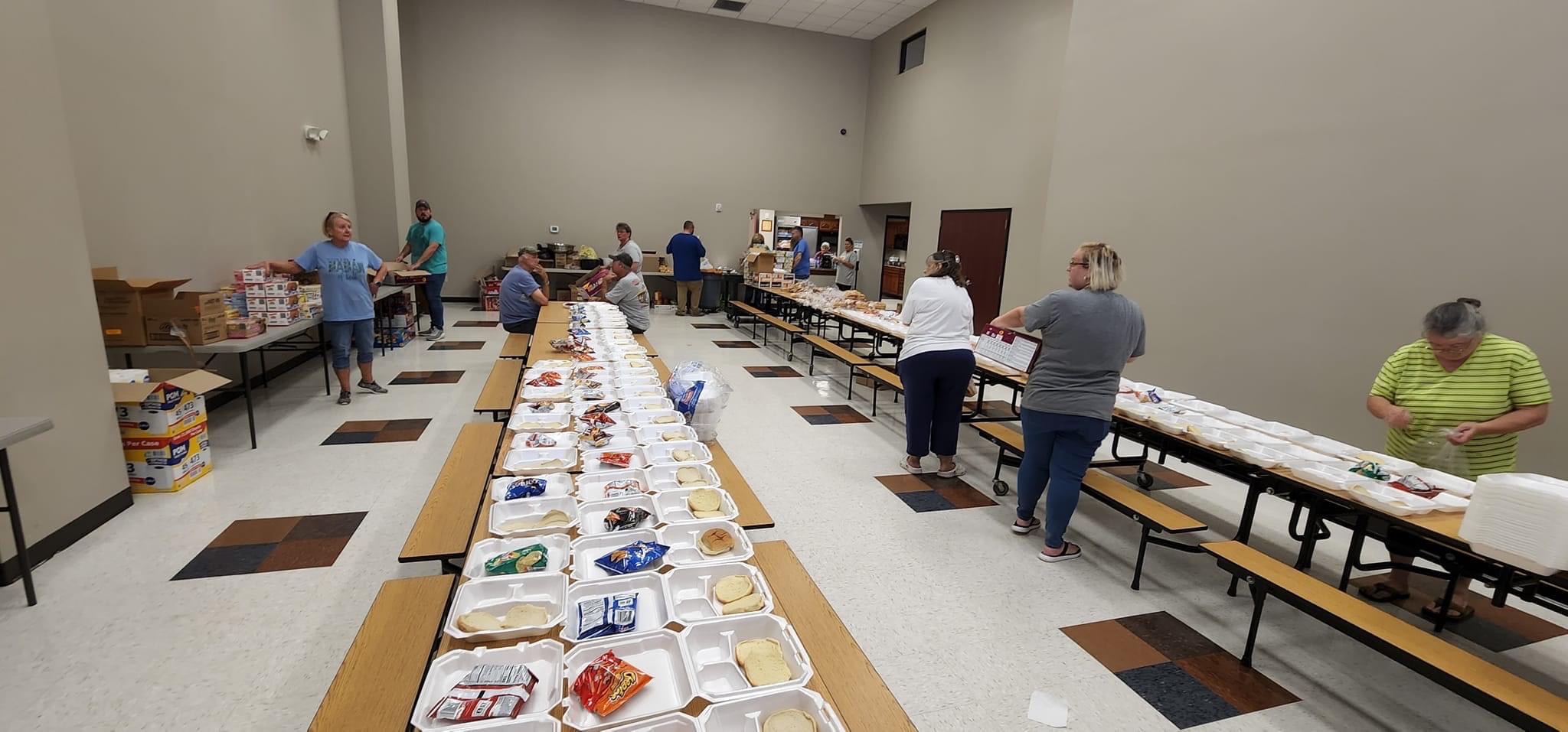 An assembly line of tables covered in meals
