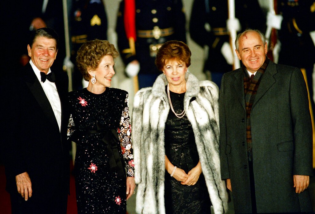 President Ronald Reagan and first lady Nancy Reagan greet Soviet leader Mikhail Gorbachev and his wife Raisa outside the White House before a State Dinner, Dec. 8, 1987.