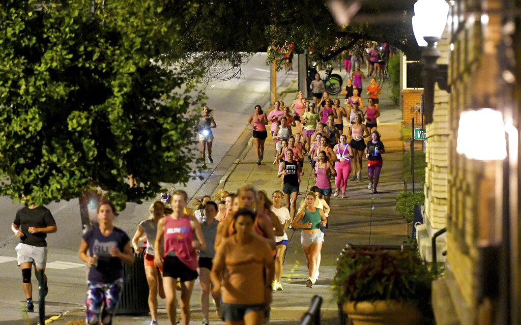 Runners head down the sidewalk past Fountain Square on Georgia Avenue during "Finish Eliza