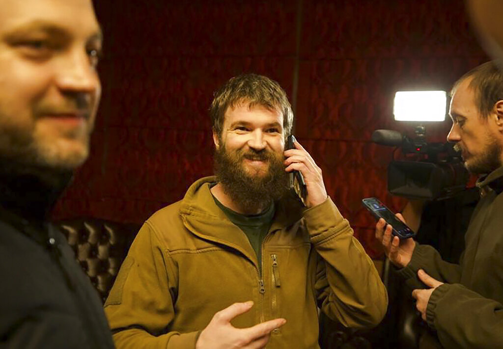 Azov officer Sviatoslav Palamar, center, who was released in a prisoner exchange between Russia and Ukraine, speaks on the phone in Ankara, Turkey
