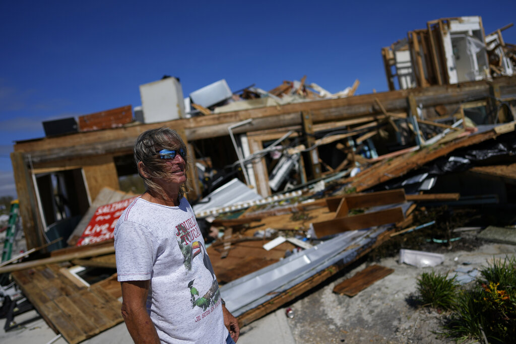 Robert Leisure surveys his business, Getaway Marina, which was destroyed during the passage of Hurricane Ian, in Fort Myers Beach, Fla.