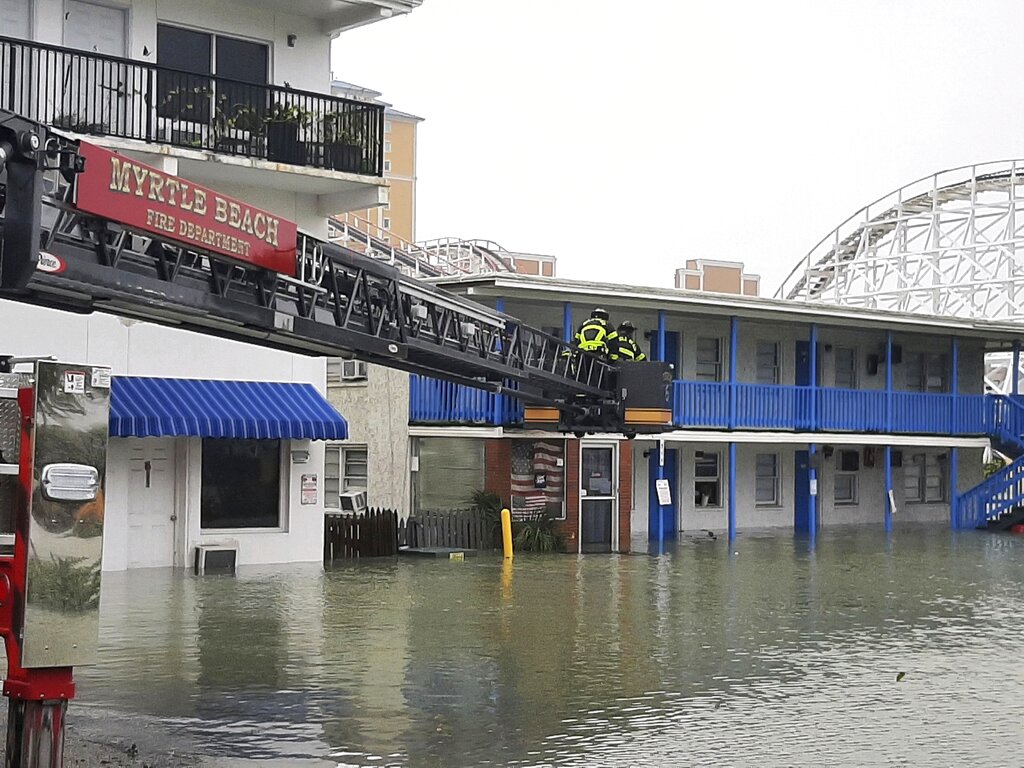 Rescuing people who were trapped on the second floor due to flooding caused by Hurricane Ian