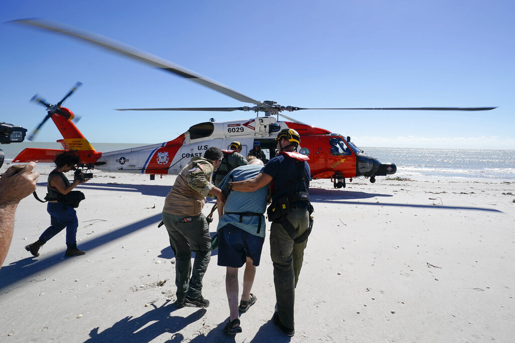 Residents of Sanibel Island are moved to a waiting U.S. Coast Guard helicopter after wethering Hurricane Ian