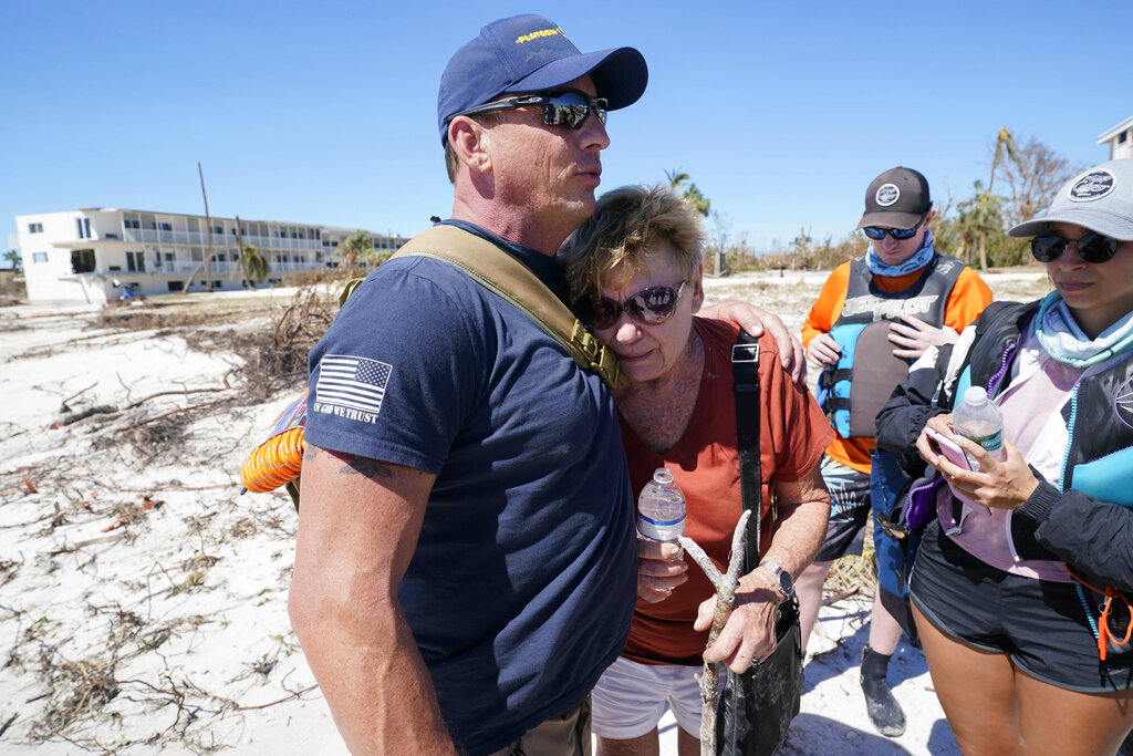 Resident Judy Hicks is embraced by Project DYNAMO rescuer Bryon Wheeldon, before she is taken off the island, in the wake of Hurricane Ian