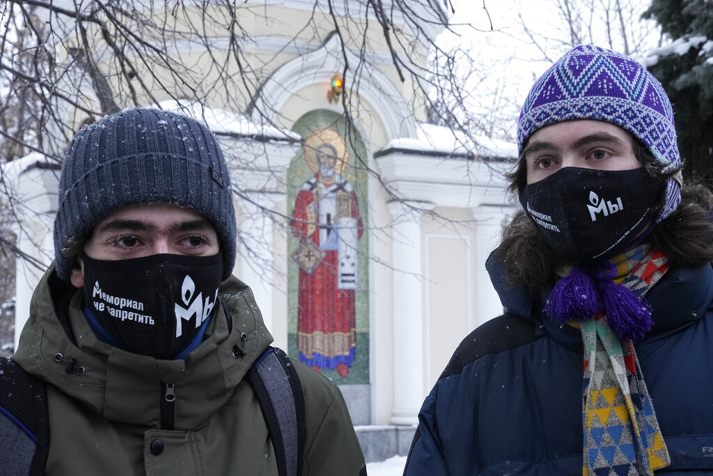 Supporters of the Memorial human rights group wearing face masks with the words "The Memorial cannot be banned!" gather in front of the Moscow Court in Moscow, Russia