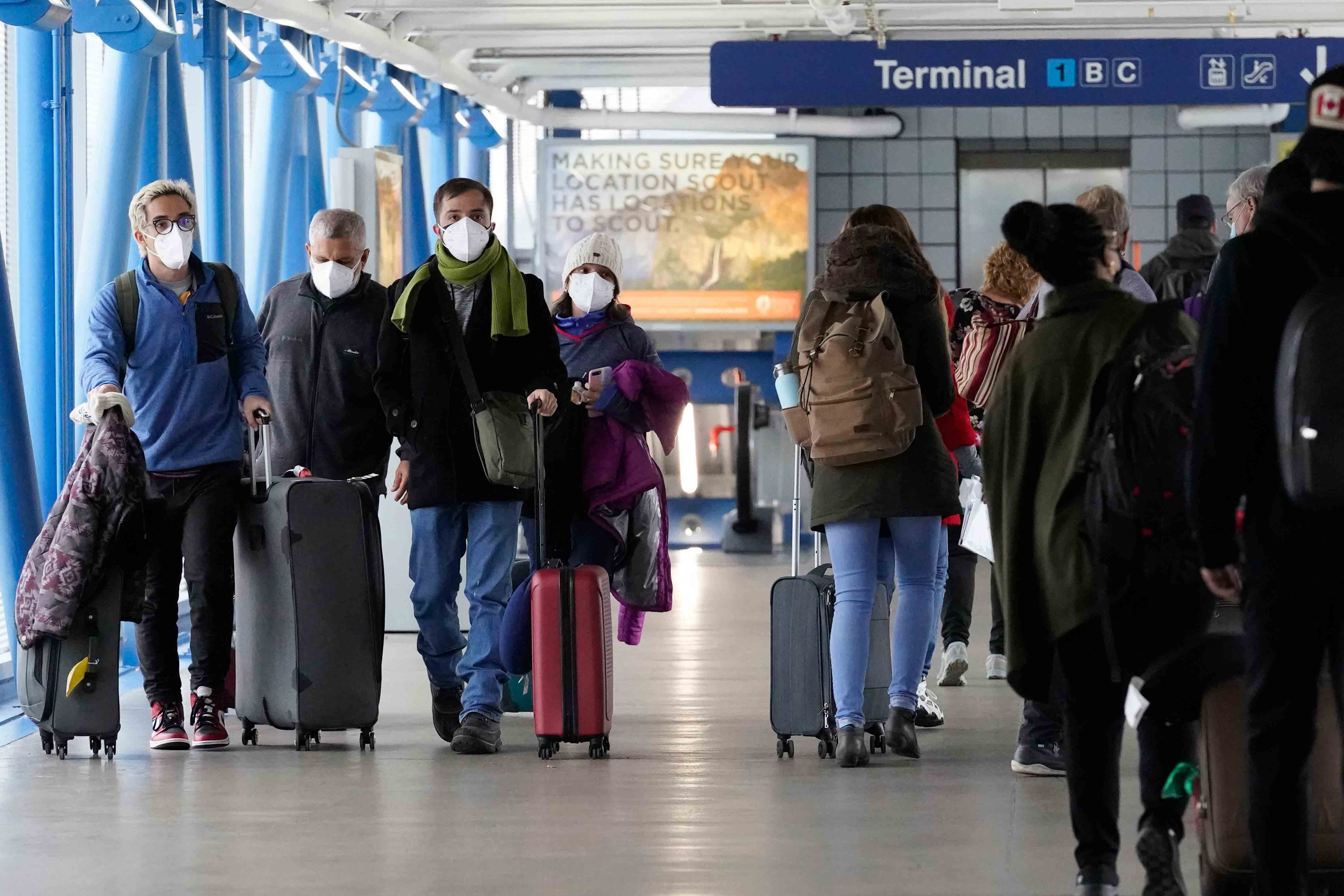 Travelers walk through Terminal 1 at O