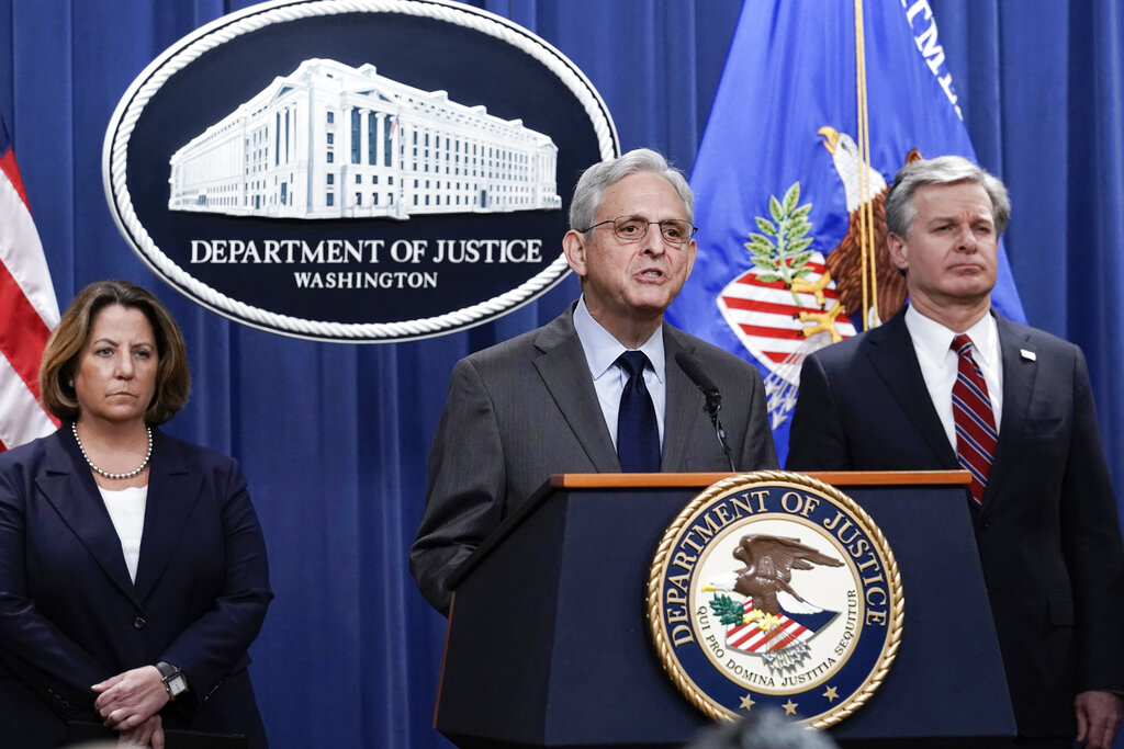 Attorney General Merrick Garland, center, flanked by Deputy Attorney General Lisa Monaco, left, and FBI Director Christopher Wray, speaks to reporters as they announce charges against two men suspected of being Chinese intelligence officers