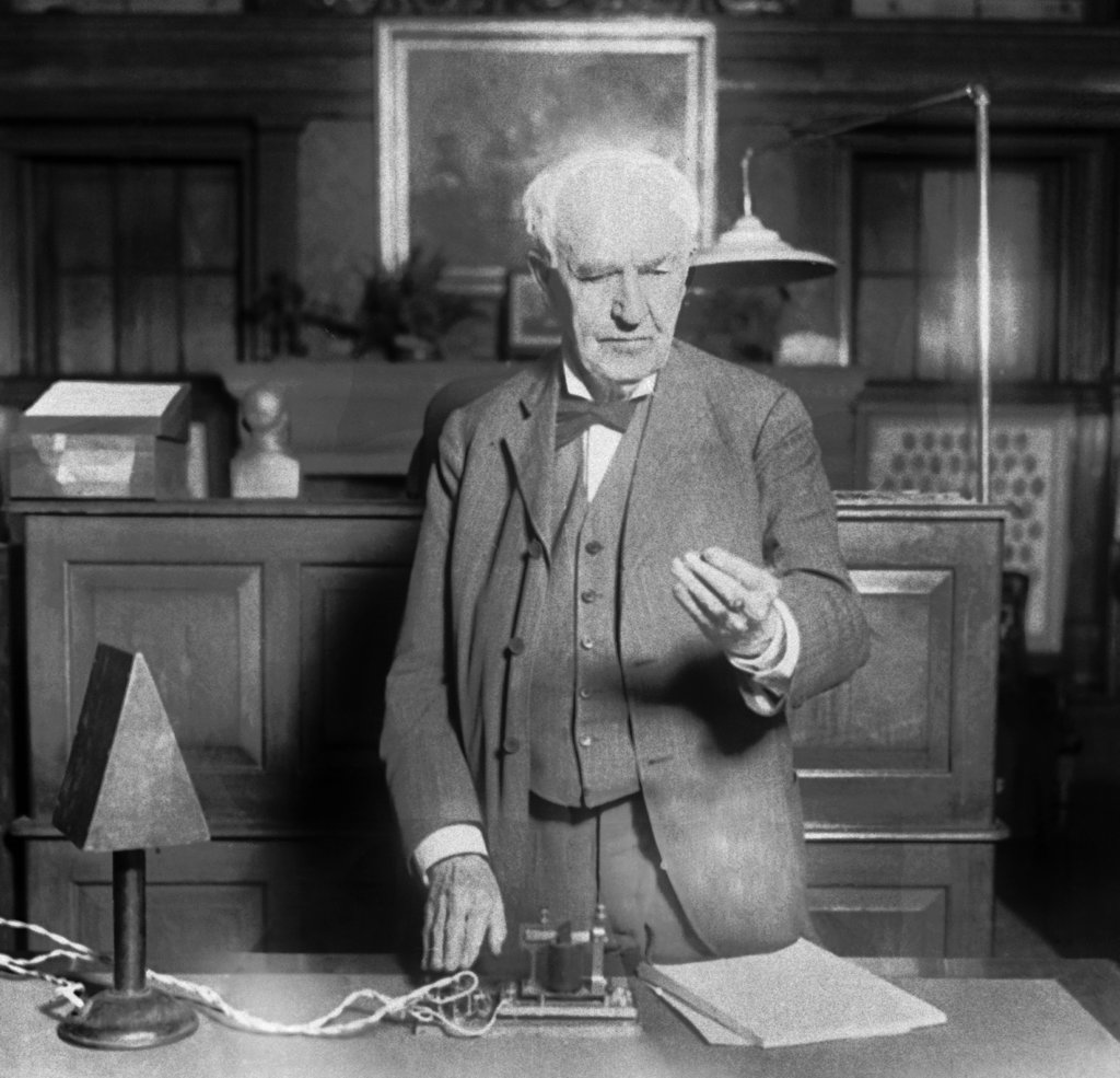 Thomas A. Edison presses the button in West Orange, N.J., which turns on street lights in Seattle