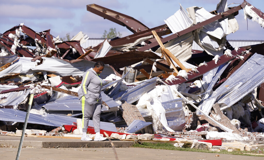 Adela Cox looks at the Trinity Baptist Church that was destroyed by a tornado in Idabel, Okla.