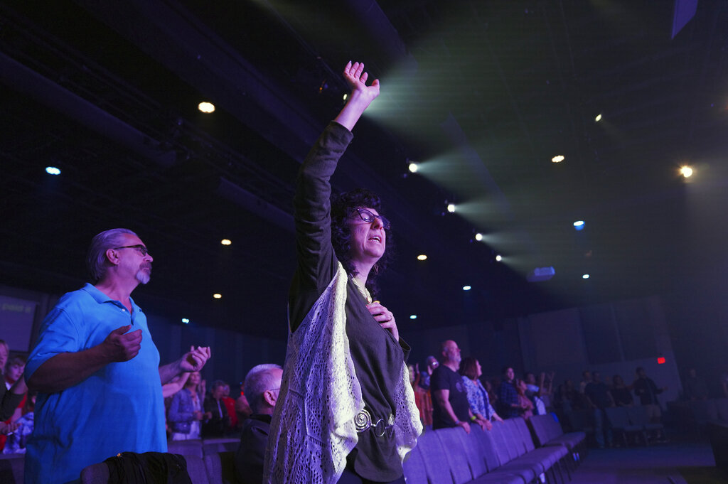 Judy Perella raises her hand in worship during service at Allison Park Church