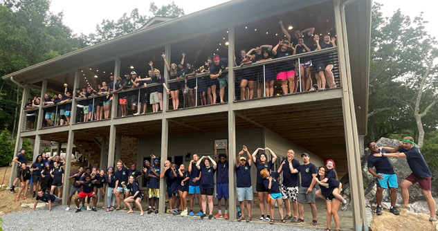 50+ kids standing on a balcony and a porch