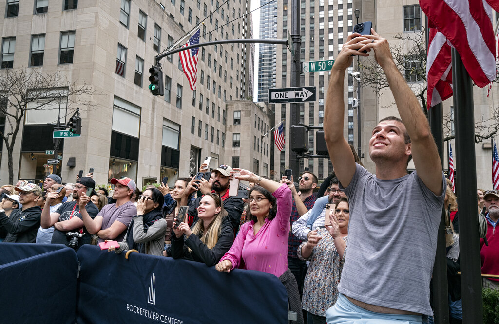 Spectators watch as the 2022 Rockefeller Center Christmas is lifted into place 