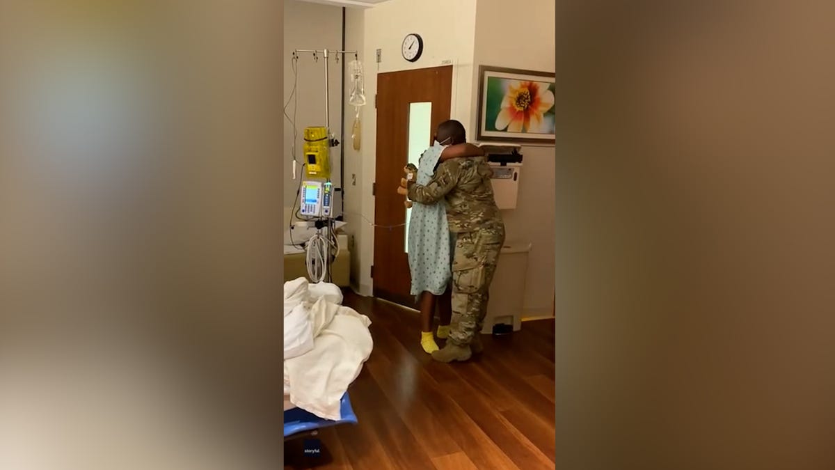 U.S. Army National Guard Doctor Harold Leroy hugs his wife