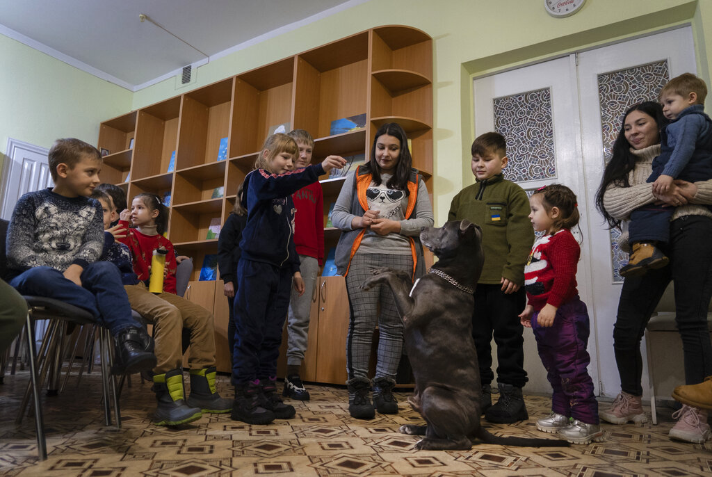 Children traumatized by the war pose for photo with an American Pit Bull Terrier "Bice" in the Center for Social and Psychological Rehabilitation in Boyarka close Kyiv, Ukraine