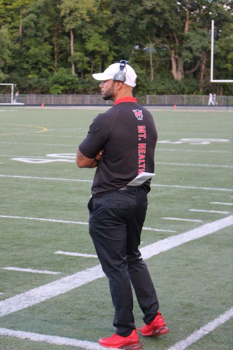 Coach Jordan Stevens on the football field