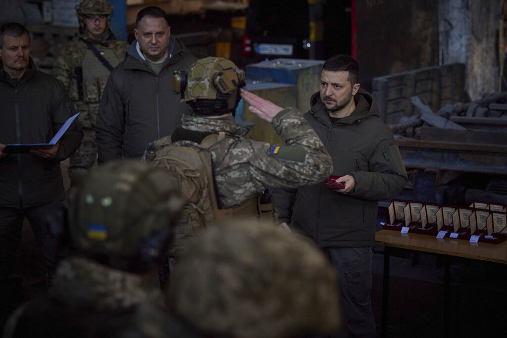 Ukrainian President Volodymyr Zelenskyy awards a serviceman at the site of the heaviest battles with the Russian invaders in Bakhmut, Ukraine