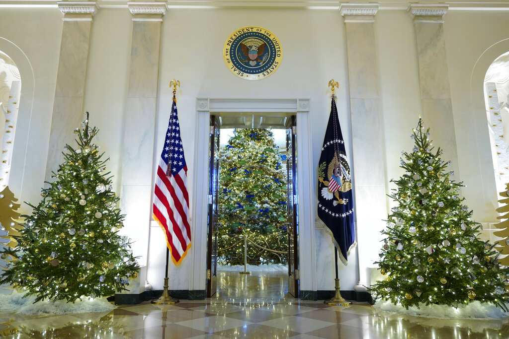 Cross Hall and the Blue Room of the White House are decorated for the holiday season