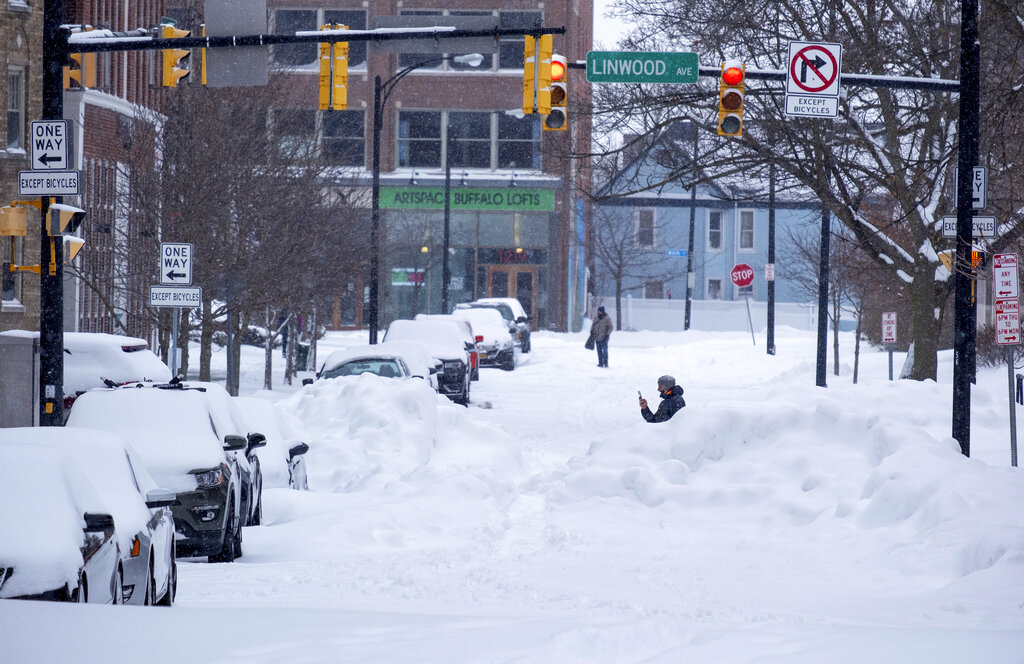 People move about the streets of the Elmwood Village neighborhood of Buffalo, N.Y